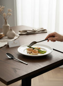 Paniery African Cutlery Set in black, featuring Adinkra symbols, with a fork holding asparagus over scallops.