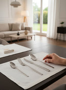 Paniery African Cutlery Set in silver with Adinkra design, 24 pieces. Features crossed pattern and wave motif.