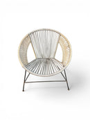 Paniery Signature Atlas Chair, handwoven from recycled fishing lines in off-white and tan, with a sculptural round frame and dark metal legs.