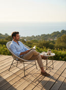 Paniery Signature Atlas Chair, handwoven white recycled fishing lines, modern sculptural design, for indoor/outdoor use.