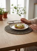 Paniery dark grey beaded placemat with sunburst pattern, handcrafted for table art and dining.