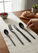 Paniery black cutlery set with Adinkra wave and crossed patterns, 24 pieces, luxury dining.
