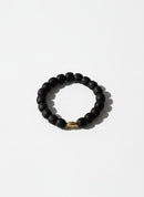Paniery black recycled glass beaded bracelet with a single gold bead accent, unisex design.
