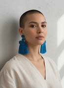 Paniery blue handwoven tassel earrings with coiled detail on top.