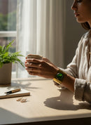 Paniery handmade brass cuff bracelet with a large, round, green cabochon stone. Recycled metal.