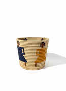 Paniery handwoven natural straw basket with bold navy blue and mustard yellow graphic pattern, perfect for storage or decor.
