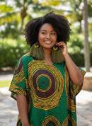 Paniery handwoven earrings from Rwanda with a spiral design in red, yellow, green, and black, featuring long fringe tassels in mixed colors.