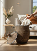 Paniery luxury handwoven laundry basket in natural fibers with full leather trim. Features a lid and handles. Perfect for storage or decor.