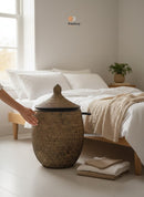 Paniery luxury handwoven laundry basket in natural fibers with full leather trim, featuring a lidded design and a unique artisanal finish.
