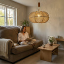 Paniery handwoven natural raffia lampshade with an organic shape, casting a warm diffused light. Moroccan craftsmanship.