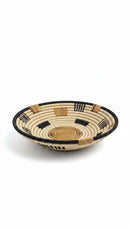Paniery handwoven wall basket made of natural fibers in beige, black, and tan with geometric patterns. Perfect for African art decor.