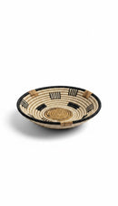 Paniery handwoven wall basket made from natural fibers in beige, black, and tan with a striped pattern.