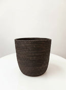 Paniery mini handwoven vase from Rwanda, made of dark natural fibers, 20 cm tall, with a textured ribbed design.