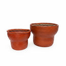 Paniery handwoven orange leather and seagrass drum-inspired baskets, available in two sizes. Perfect for storage or as planters.