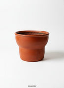 Paniery handwoven drum-inspired basket in orange leather, seagrass, and recycled plastic. Versatile for storage or as a planter.