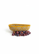 Paniery oval handwoven basket in natural fibers with yellow geometric pattern, ideal for serving or decor.