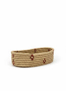 Paniery oval handwoven basket made from natural fibers with red stripe accents, perfect for table or home decor.