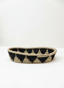 Paniery oval handwoven basket in natural fibers with black geometric pattern, ideal for table or home decor.