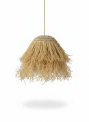 Paniery handwoven natural raffia lampshade with a unique organic shape and fringed bottom, casting a diffused light.