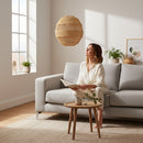 Paniery handwoven natural raffia pendant lampshade with a sculptural, geometric design, creating ambient light.