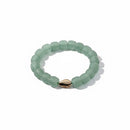 Paniery light green recycled glass beaded bracelet with a single cowrie shell accent. Unisex design.