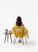 Paniery Signature Solis Chair in bright yellow, handwoven from recycled fishing lines with a sculptural radial design.