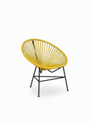 Paniery Signature Solis Chair in bright yellow, handwoven from recycled fishing lines with a black metal frame. Compact sculptural design.