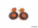 Paniery orange and navy blue handwoven spiral statement earrings. Lightweight and comfortable for everyday wear.