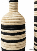 Paniery handwoven African floor vase with black and natural striped pattern made from natural fibers.