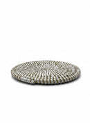 Paniery handwoven round coaster in white and natural straw, featuring a spiral pattern and durable design.