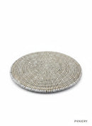 Paniery white handwoven round rattan coaster, durable and elegant design for table protection.