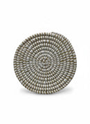 Paniery handwoven white and natural straw round coaster, detailed woven pattern.