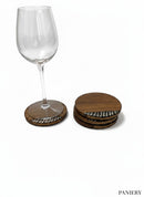 Paniery handcrafted wooden coasters with a natural wood grain and a decorative black and white inlay pattern. Set of 5.