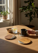 Paniery handcrafted wooden coasters with a natural wood grain and a decorative black and white striped inlay. Set of four.