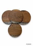 Paniery handcrafted wooden coasters with zebra-patterned inlay. Natural wood finish, unique African design.