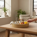 Paniery natural woven tray with breakfast items, including coffee, croissant, and orange juice.