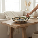 Paniery 40 cm natural sweetgrass woven tray with black geometric pattern, filled with stones and eucalyptus.
