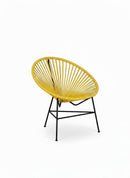 Paniery Signature Solis compact chair in yellow, handwoven from recycled fishing lines with a black metal frame.