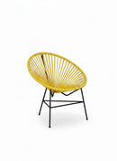 Paniery Signature Solis chair in yellow, handwoven from recycled fishing lines with a black metal frame. Compact sculptural design.