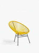 Paniery Signature Solis Chair in bright yellow, handwoven from recycled fishing lines with a black metal base. Features a radial design.